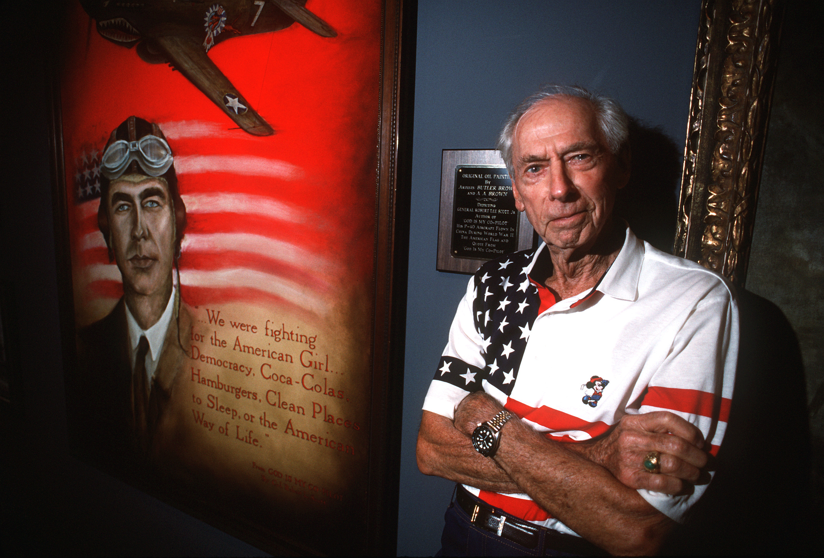 Retired Gen. Robert Lee Scott, Jr. pictured next to an original oil painting of himself. 